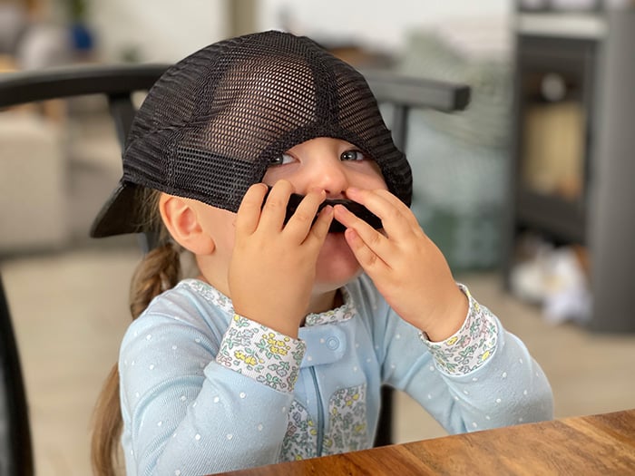 Isabella playing with a hat